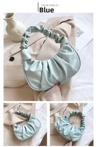 Detail of light blue cloud-shaped pleated handbag showing soft PU leather and ruched handle