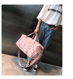 Pink fitness bag detail showing separate shoe compartment and waterproof nylon fabric texture