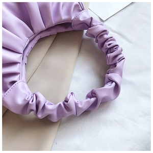 Detail of lavender pleated PU leather shoulder bag showing soft gathered texture and handle