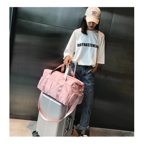 Pink travel bag with independent shoe compartment and spacious interior for gym use