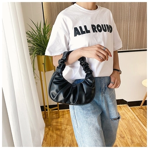 Detail of black PU leather pleated cloud bag showing unique ruched texture and handle