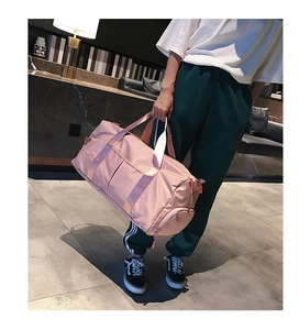 Close-up of pink nylon sports bag with reinforced straps and side zipper pocket