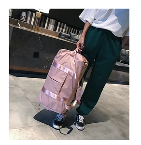 Pink fitness duffel bag with reinforced fabric handles and a side zippered pocket
