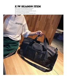 Detail of multi-functional black sports bag with adjustable strap and front dual pockets