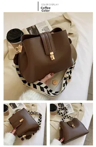 Detail view of coffee bucket bag with stylish geometric woven wide shoulder strap