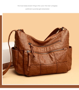 Detailed close-up of brown vintage crossbody bag with multi-zipper pockets and quilted texture