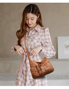 Brown vintage faux leather shoulder bag featuring multiple zipper pockets and tassel details