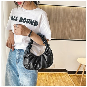 Detail of black pleated PU leather cloud bag showing soft texture and ruched strap