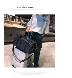 Black gym bag with luggage handle sleeve design for easy travel and portability