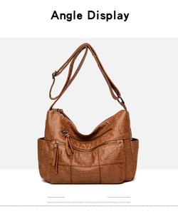 Detailed view of brown vintage PU leather handbag with fringe zippers and multiple pockets