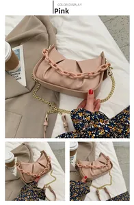 Detail of pink ruched cloud bag with acrylic resin chain and gold metallic strap