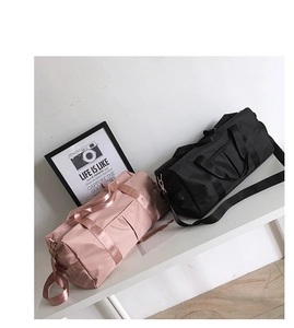 Detailed view of pink and black gym bags with waterproof fabric and adjustable straps