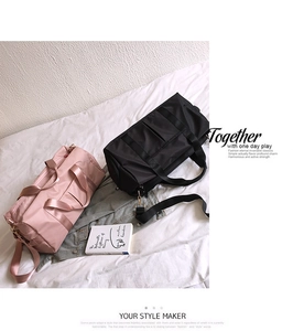 Detail of waterproof nylon gym bag with widened handles and detachable metal hooks