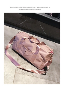 Macro detail of a rose pink fitness bag showing water-resistant fabric and zippers