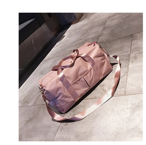 Pink waterproof sports gym bag with shoe compartment and adjustable shoulder straps