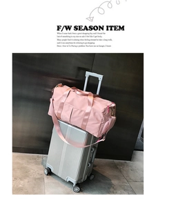 Pink nylon fitness bag on suitcase showing separate shoe compartment and large capacity
