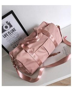 Detailed view of pink yoga bag with separate shoe compartment and shoulder strap