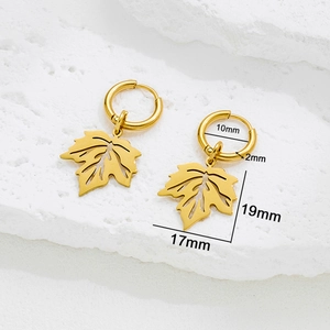Minimalist gold maple leaf hoop earrings with product dimensions on a white stone background