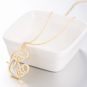 Ethnic style gold necklace with abstract mother and child pendant for Mother's Day gift