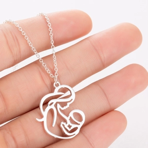Silver mother and child necklace pendant featuring a minimalist caring embrace design