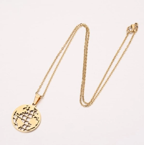 Macro detail of golden world map pendant with hollow globe design on fine cross chain