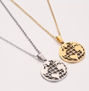 Detailed view of hollow world map globe pendants in polished gold and silver finishes