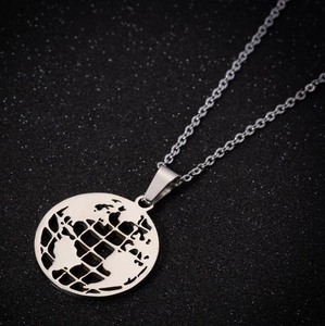 Detailed macro view of globe pendant with cutout map on stainless steel chain necklace