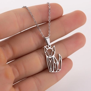 Macro view of minimalist origami fox pendant necklace with a fine silver-tone chain