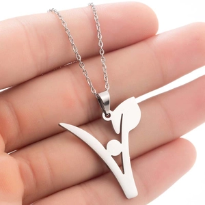 Detailed view of a silver stainless steel leaf pendant necklace held in hand