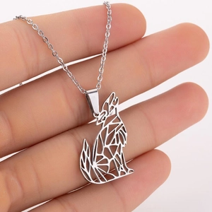 Close-up of a geometric hollow wolf pendant made of stainless steel for men
