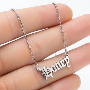 Detailed macro shot of a silver gothic Honey letter pendant on a stainless steel chain