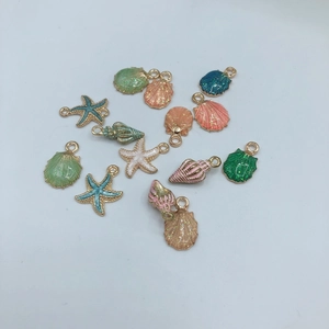 Detailed view of colorful ocean-themed DIY alloy pendants with glitter resin filling
