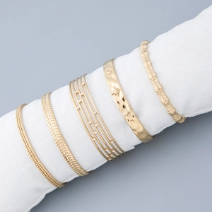 Five-piece set of gold titanium steel bracelets featuring star patterns and zircon accents
