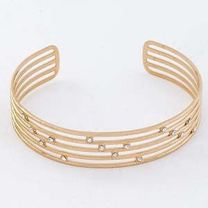 Close-up of gold titanium steel multi-layer cuff bracelet with sparkling crystal accents