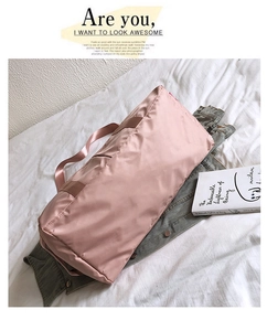 Detailed view of pink yoga fitness bag with waterproof nylon texture on casual background