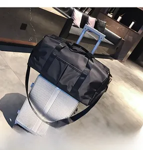 Detail of travel fitness bag featuring trolley sleeve for luggage and durable nylon handles