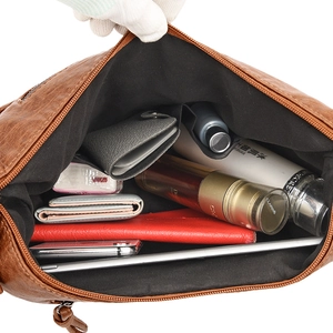 Brown faux leather tote bag with a spacious interior showing main compartment and side pockets