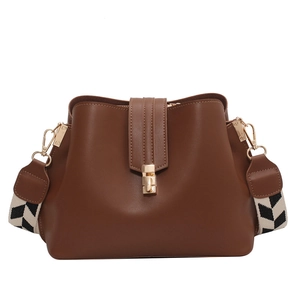 Brown bucket bag with wide geometric strap and golden lock on a white background
