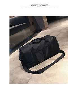 Detail of black nylon gym bag with adjustable shoulder straps and durable handles