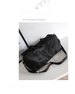 Close-up of black gym bag with large capacity, shoe compartment and gold hardware