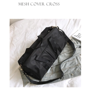 Detail of black nylon fitness bag with golden hardware zippers and adjustable strap