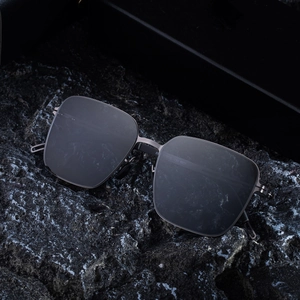 Men's square polarized sunglasses with matte black frame and nylon lenses on dark stone