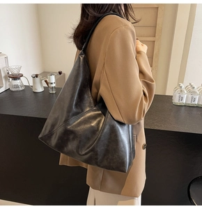 Detailed view of large retro soft leather tote bag on shoulder for commute style