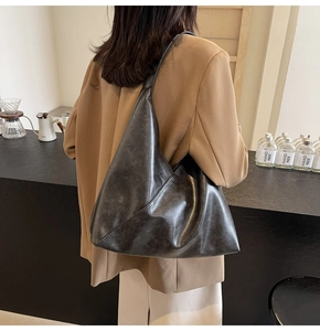 Detailed view of the vintage leather shoulder bag with triangular patchwork design
