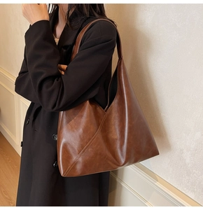 Detail of vintage brown leather tote bag showing large capacity and soft PU material