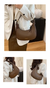 Detail of vintage brown pebble leather crescent shoulder bag with golden hardware