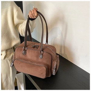 Close-up of vintage dark brown suede tote bag featuring front and side zipper pockets