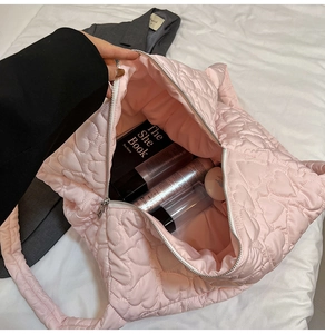 Pink heart quilted tote bag detail showing large capacity with silver zipper closure