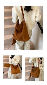 Detail view of large brown suede tote bag with matching zipper pouch and textured finish