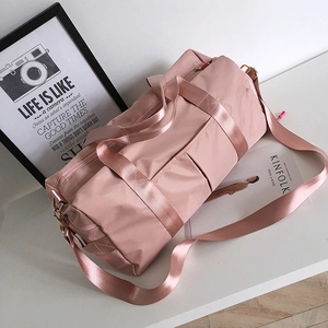 Pink waterproof nylon gym bag with shoe compartment and adjustable shoulder strap